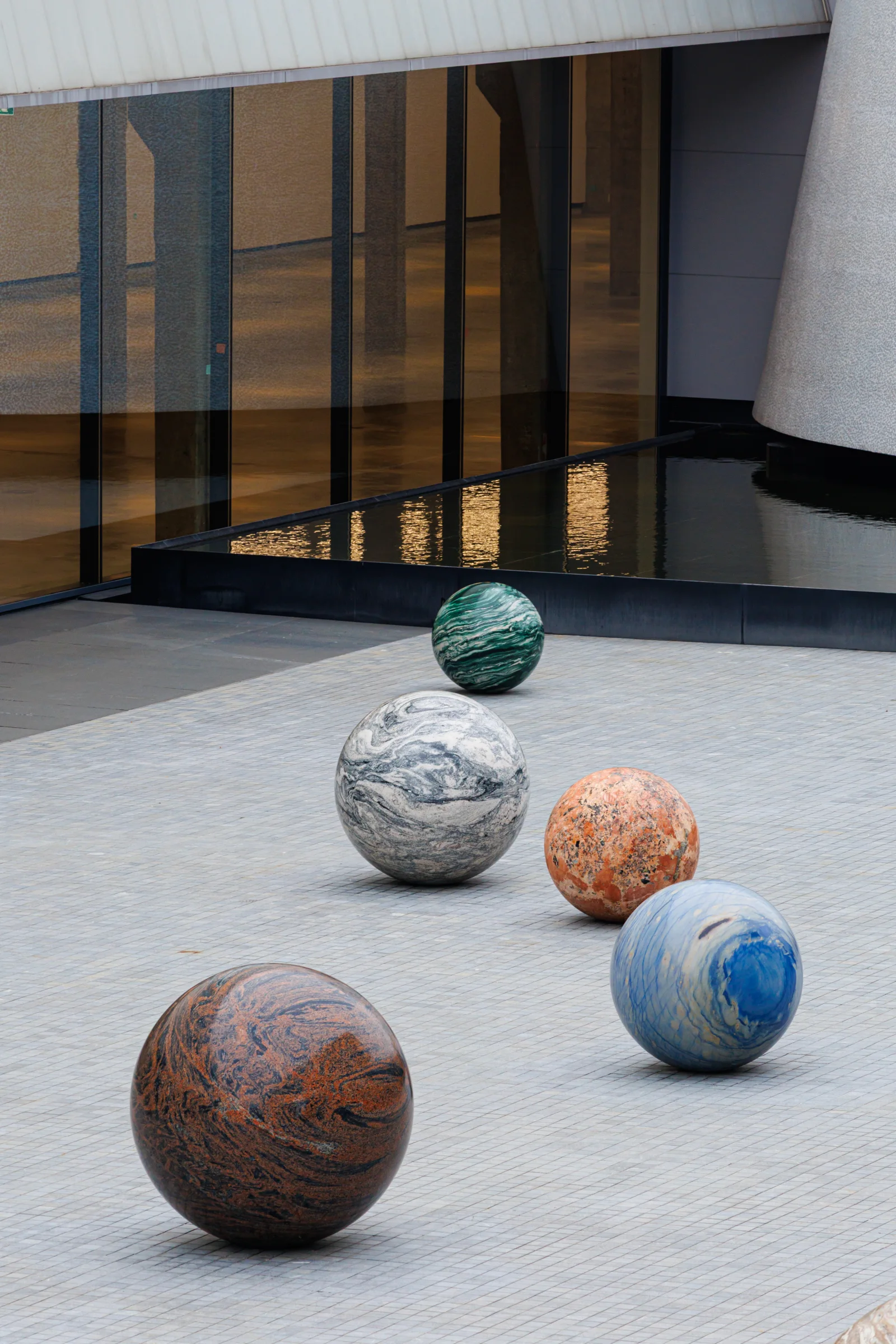 Stone spheres from Alicja Kwade’s Pars pro Toto in the courtyard at Dib Bangkok